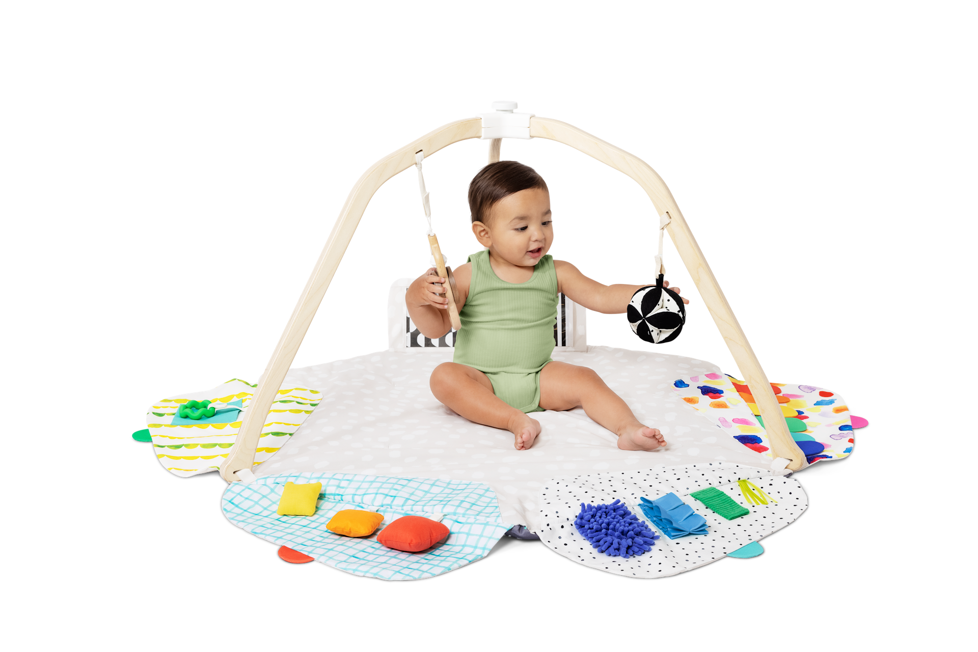 Baby playing with the High-Contrast Ball and the Batting Ring from The Play Gym by Lovevery
